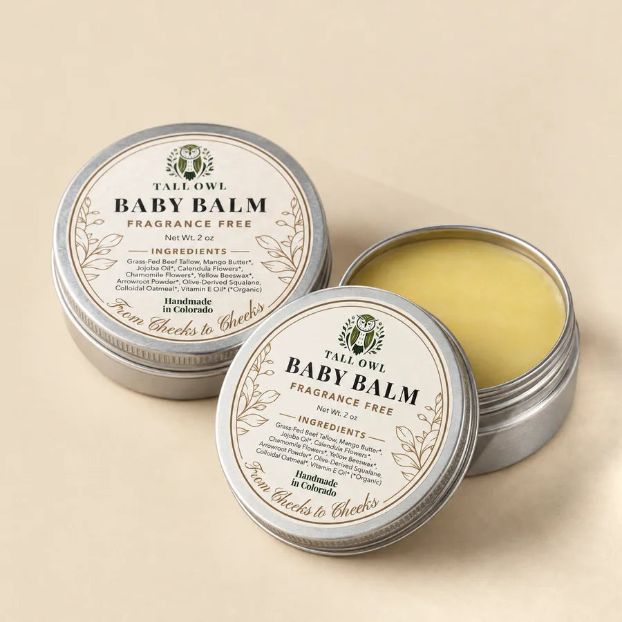 Two of Tall Owl Baby Balm, 2 oz tin open to show the balm, with its lid